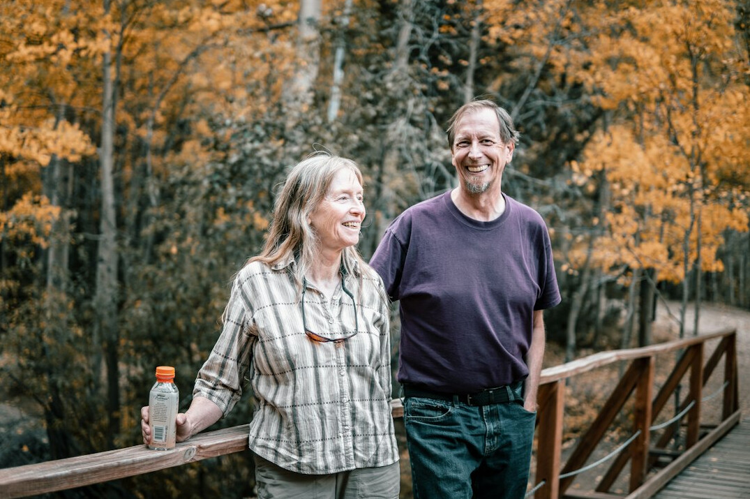 Elderly couple smiling and walking outdoors
