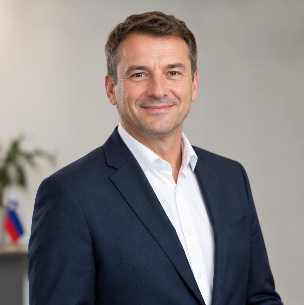 Portrait of a middle-aged man in a suit smiling in an office